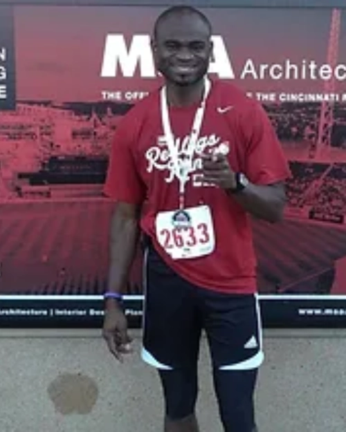 a male showing his medal