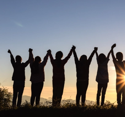 A group of people raising their hands together