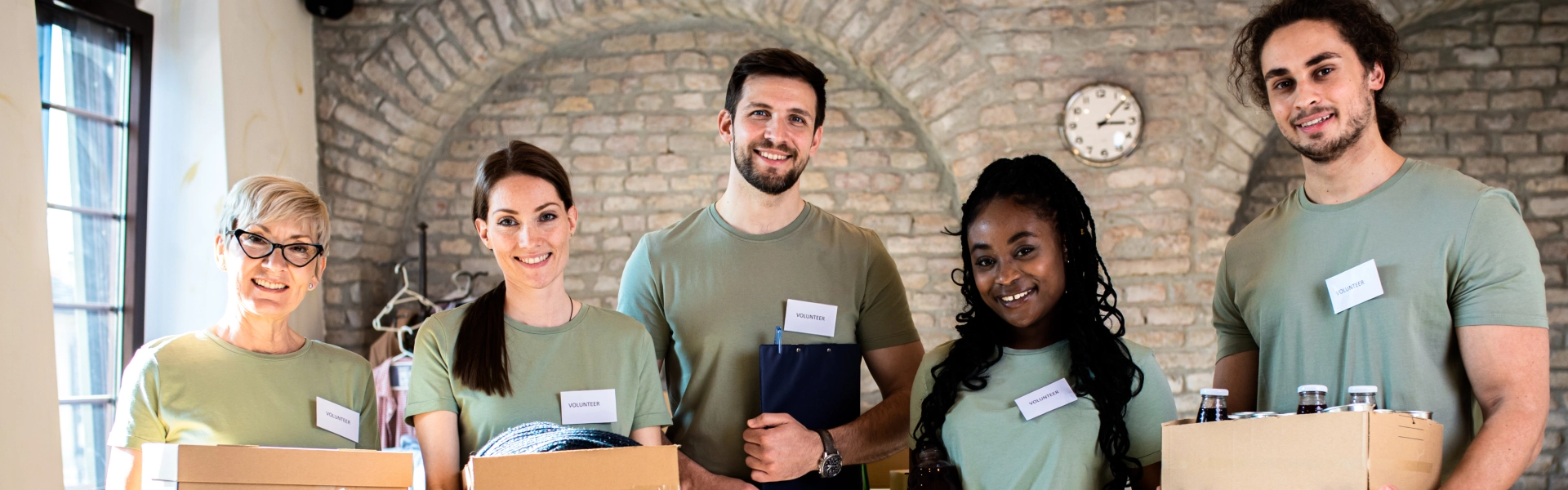 A group of volunteers carrying box